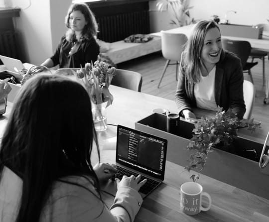 Three women working on laptops